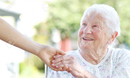 14396894-Happy-senior-woman-holding-hands-with-caretaker-Stock-Photo-elderly-people-old
