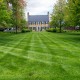 Freshly cut lawn in garden in front of an ancient villa, America.