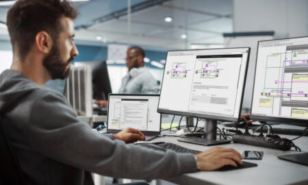 Diverse Office: Enthusiastic White IT Programmer Working on Desk